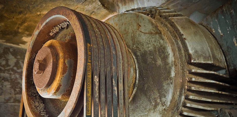 A rusty motor on a used zero turn lawn mower.
